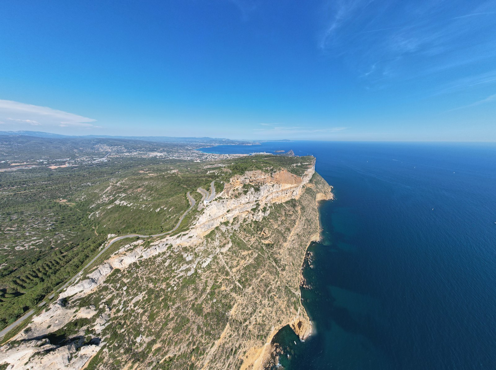 Pale limestone cliffs dropping into deep blue sea