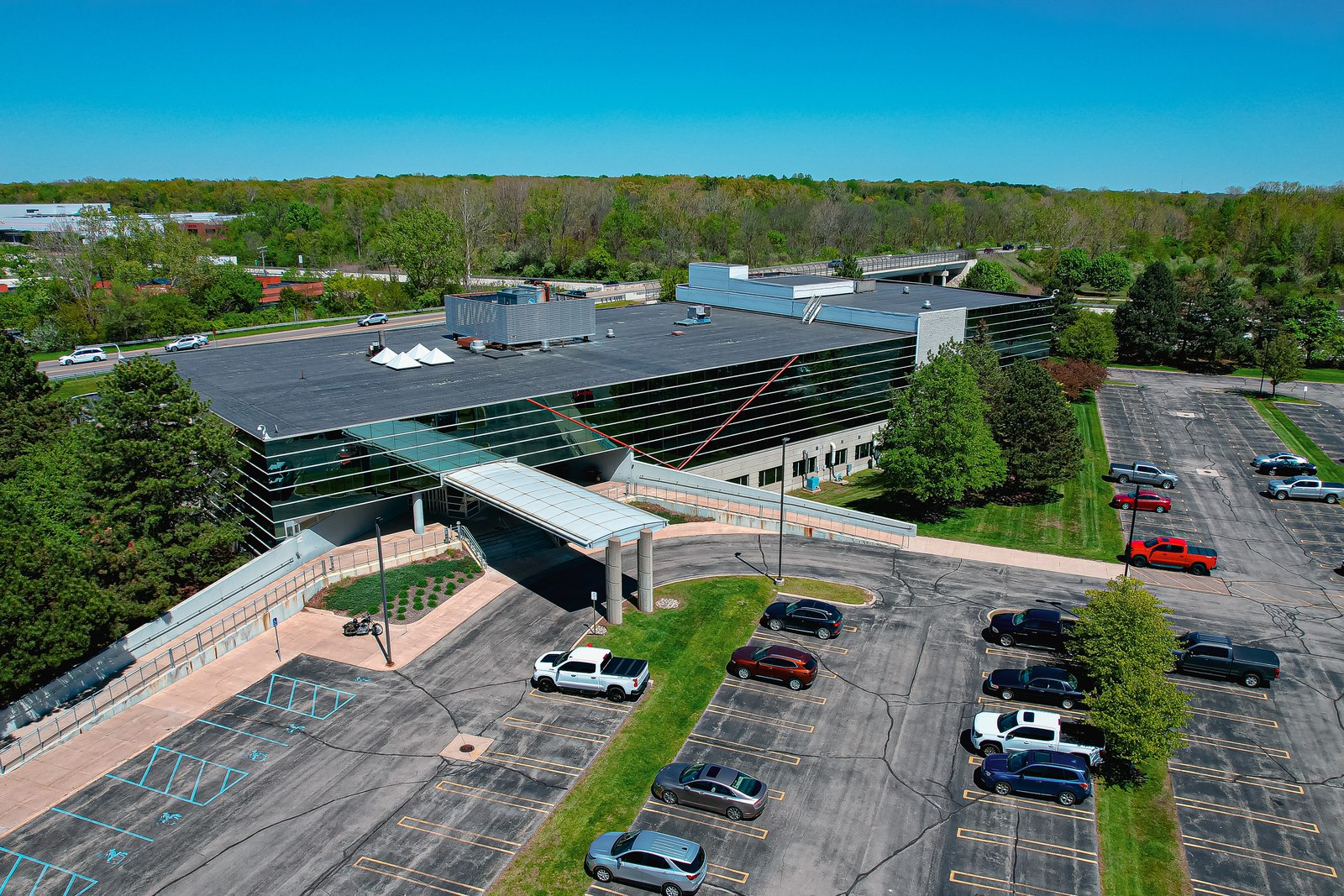 Office building, trees and parking lots on a bright spring day