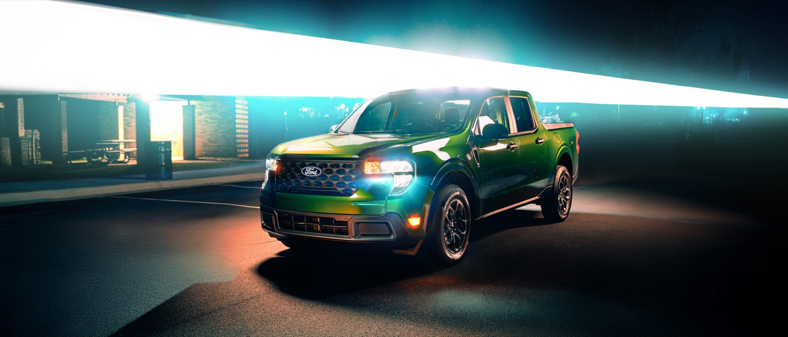 Pickup truck lit by a streak of light at night