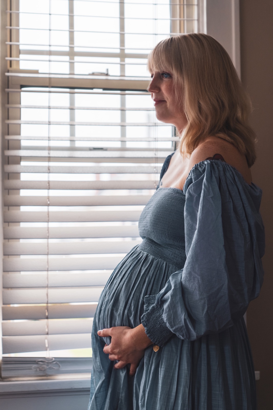 Expecting mother by a window