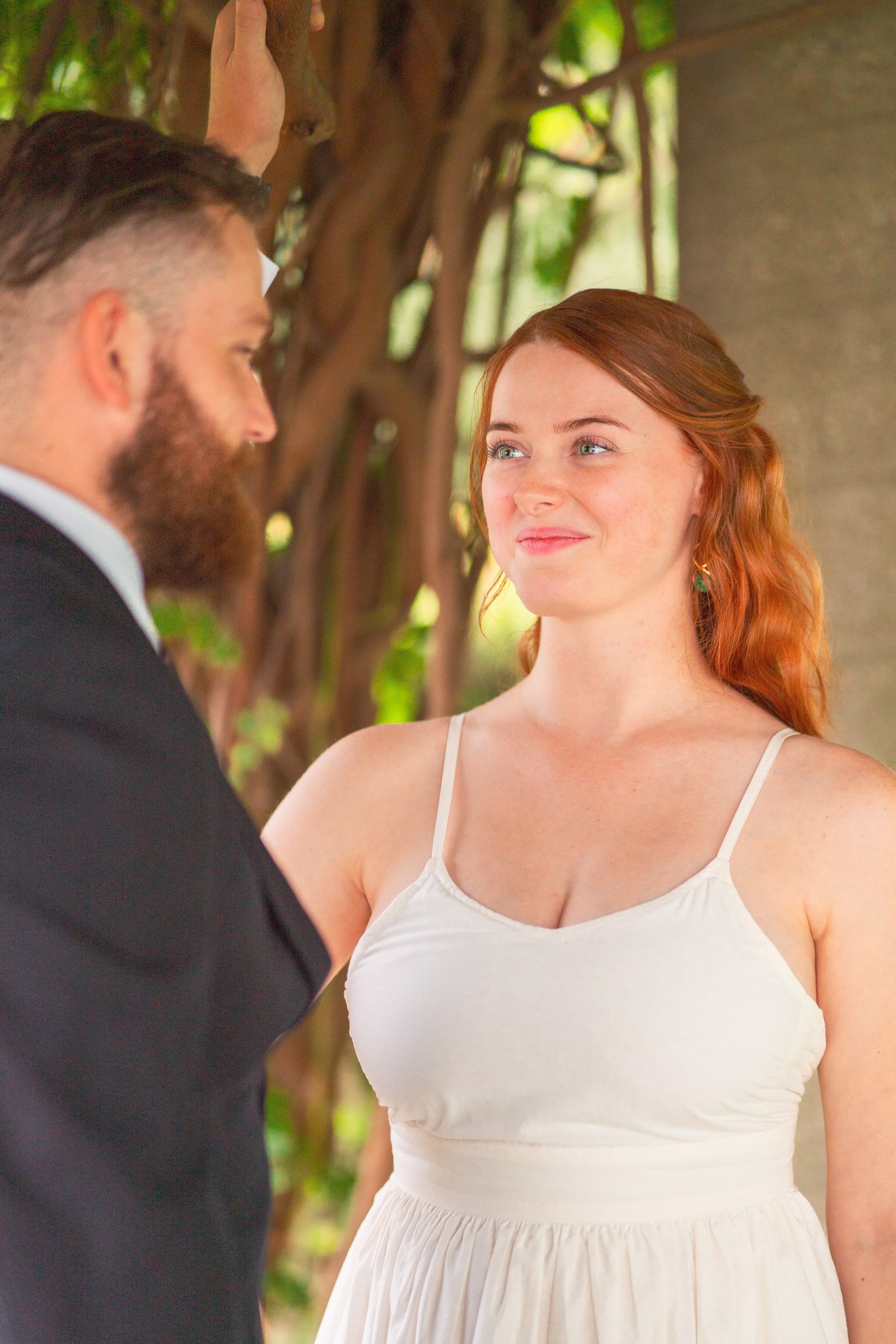 Under the arbor, his hand on her cheek