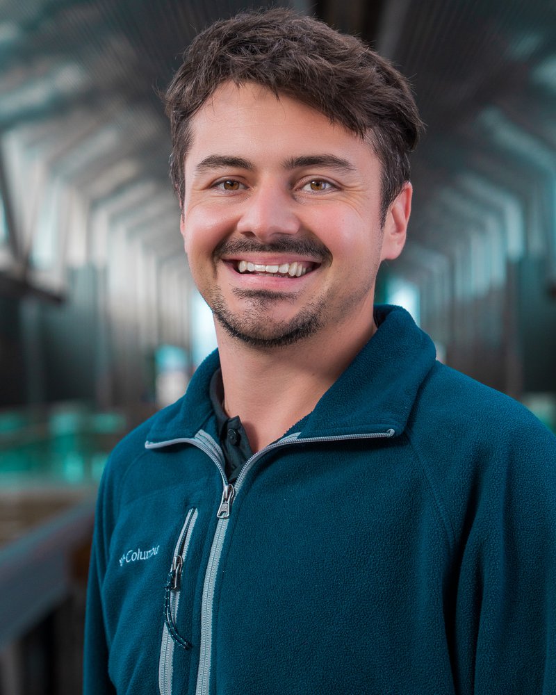 Employee headshot against the atrium, taken by Isaac