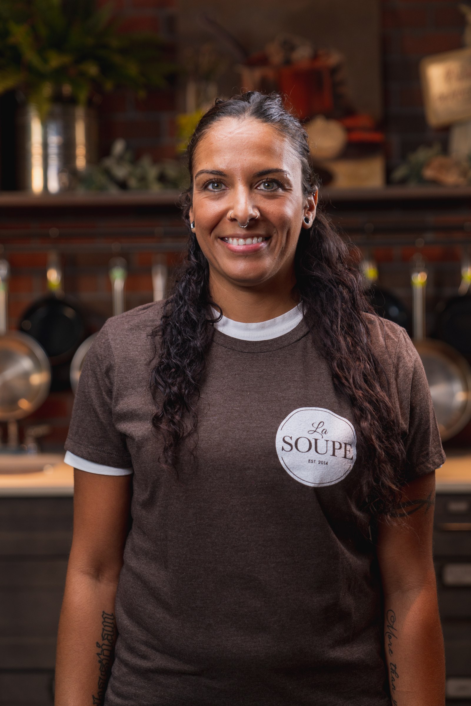 Smiling staff member in a brown La Soupe shirt