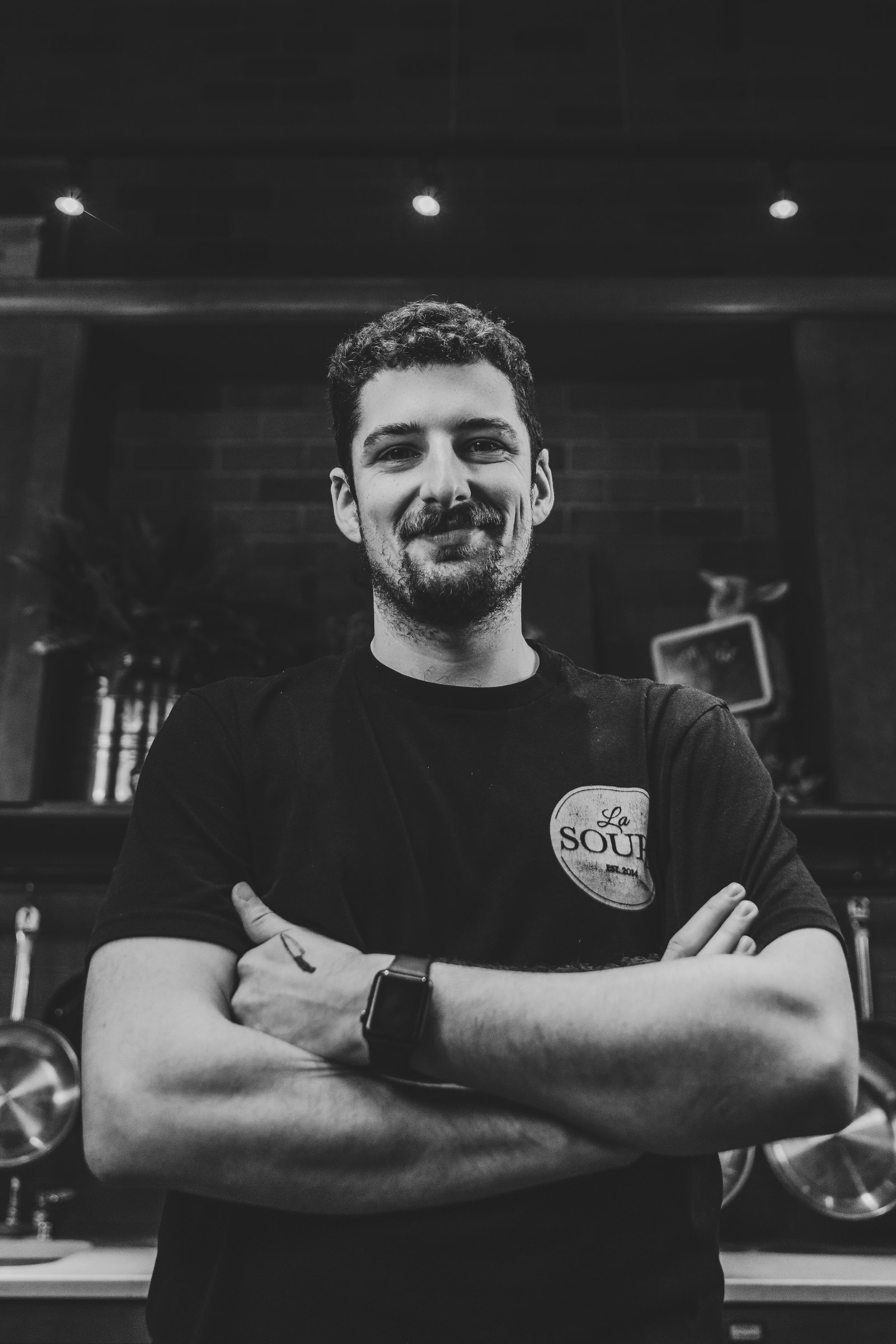 Black and white portrait of a cook with arms crossed