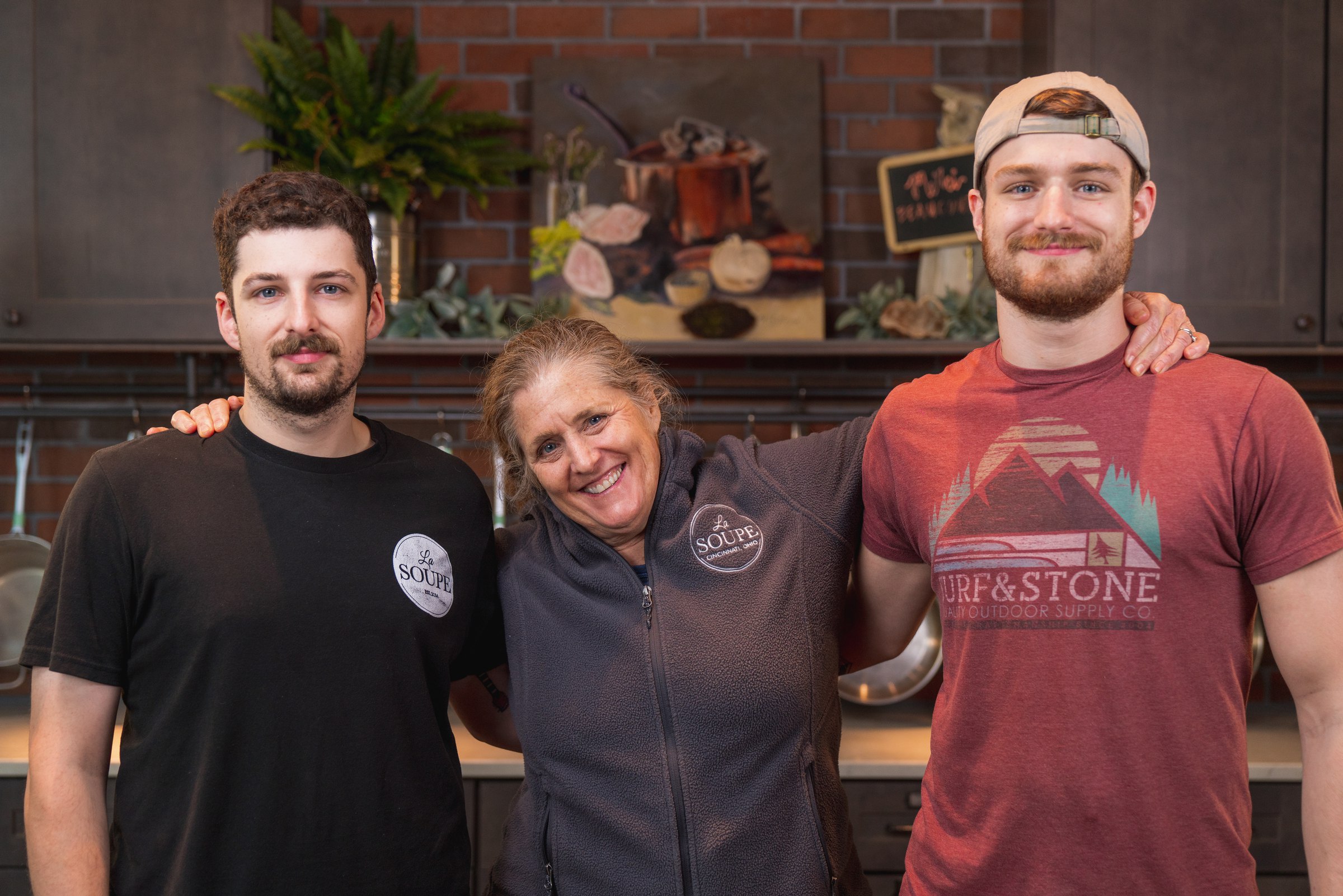 Three La Soupe staff with their arms around each other