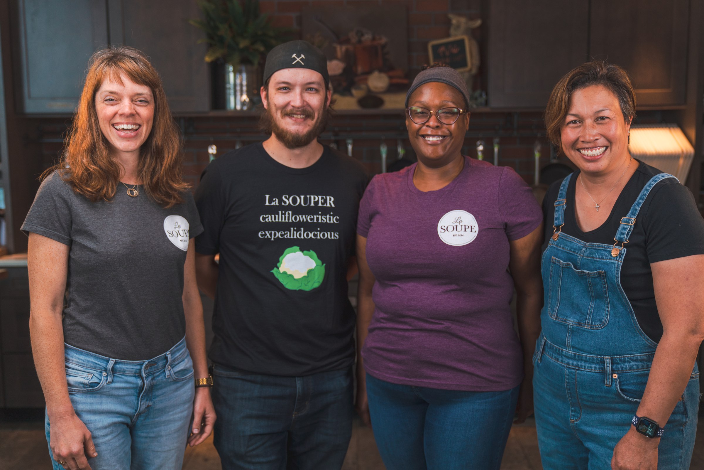 Four La Soupe staff in a row in the kitchen