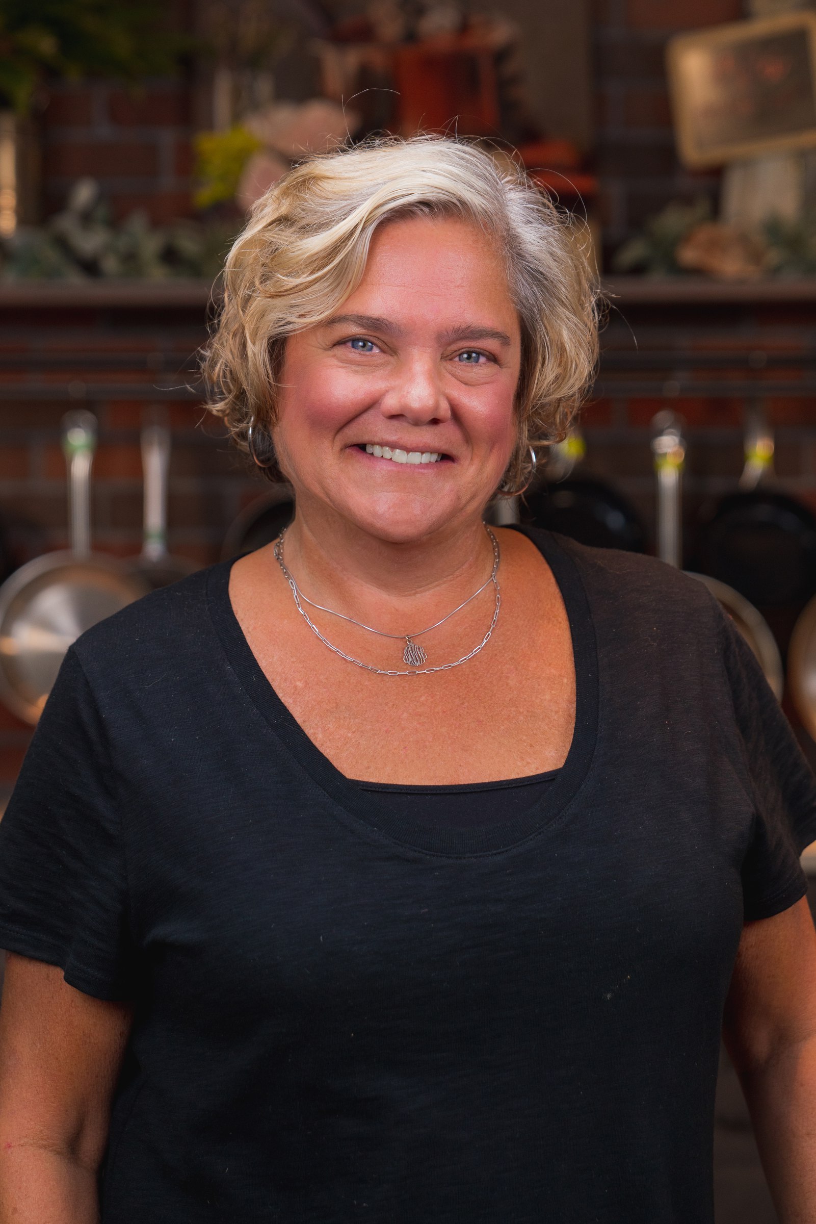 Smiling woman in a black shirt in the kitchen