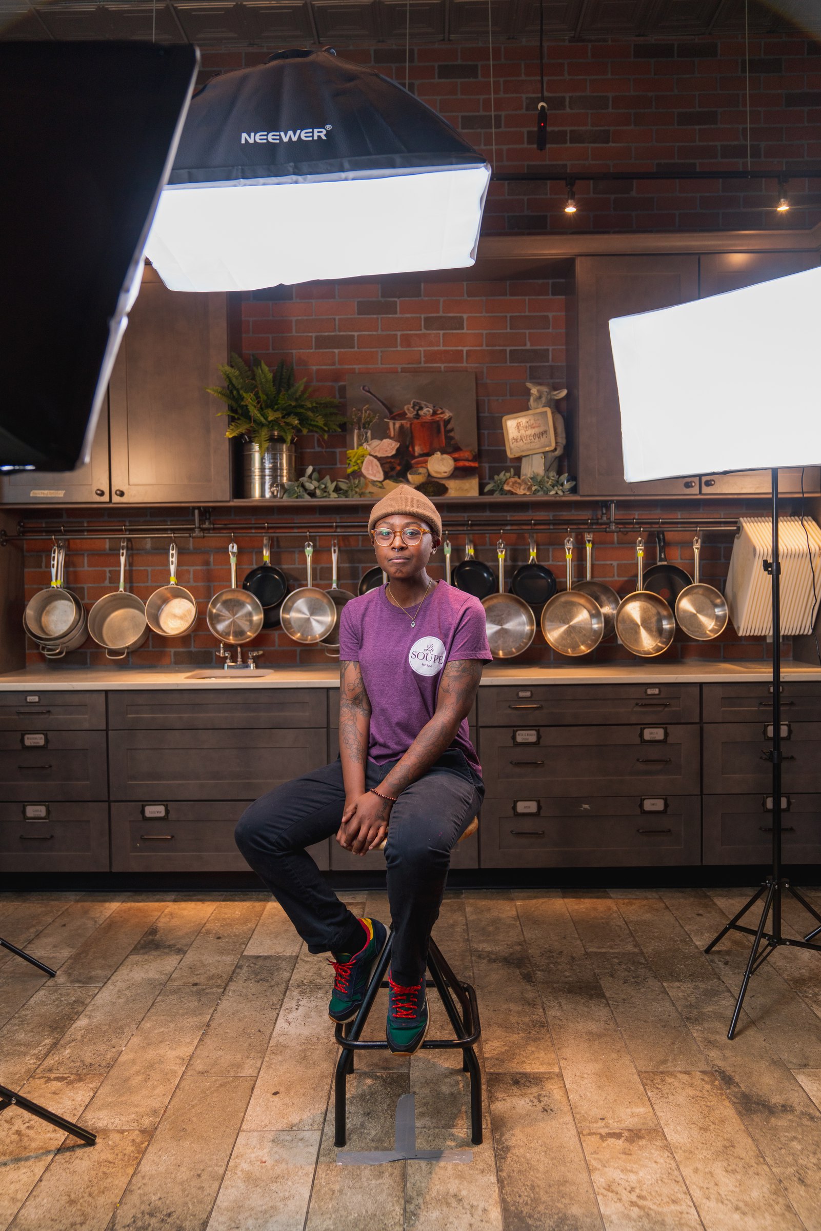 Wide view of the kitchen with softboxes set up around a stool