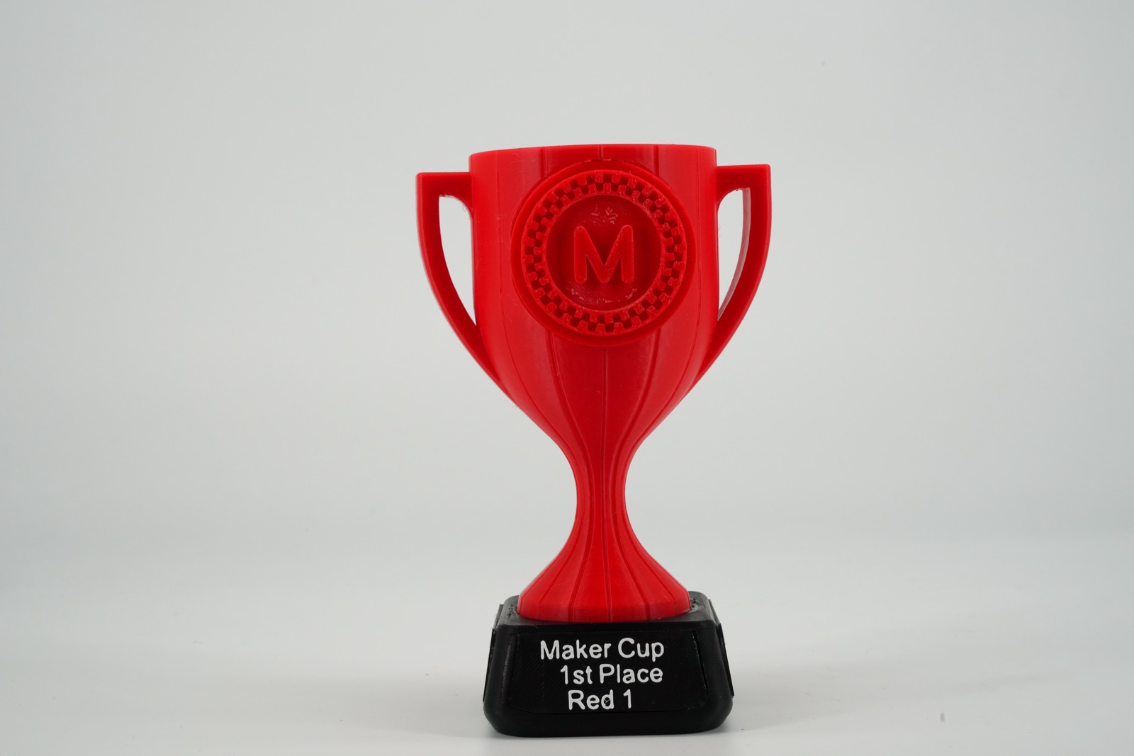 Red 3D-printed trophy with a team nameplate