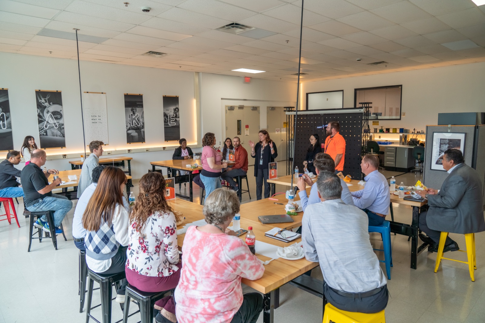 Lunch crowd at long tables in the Makerspace