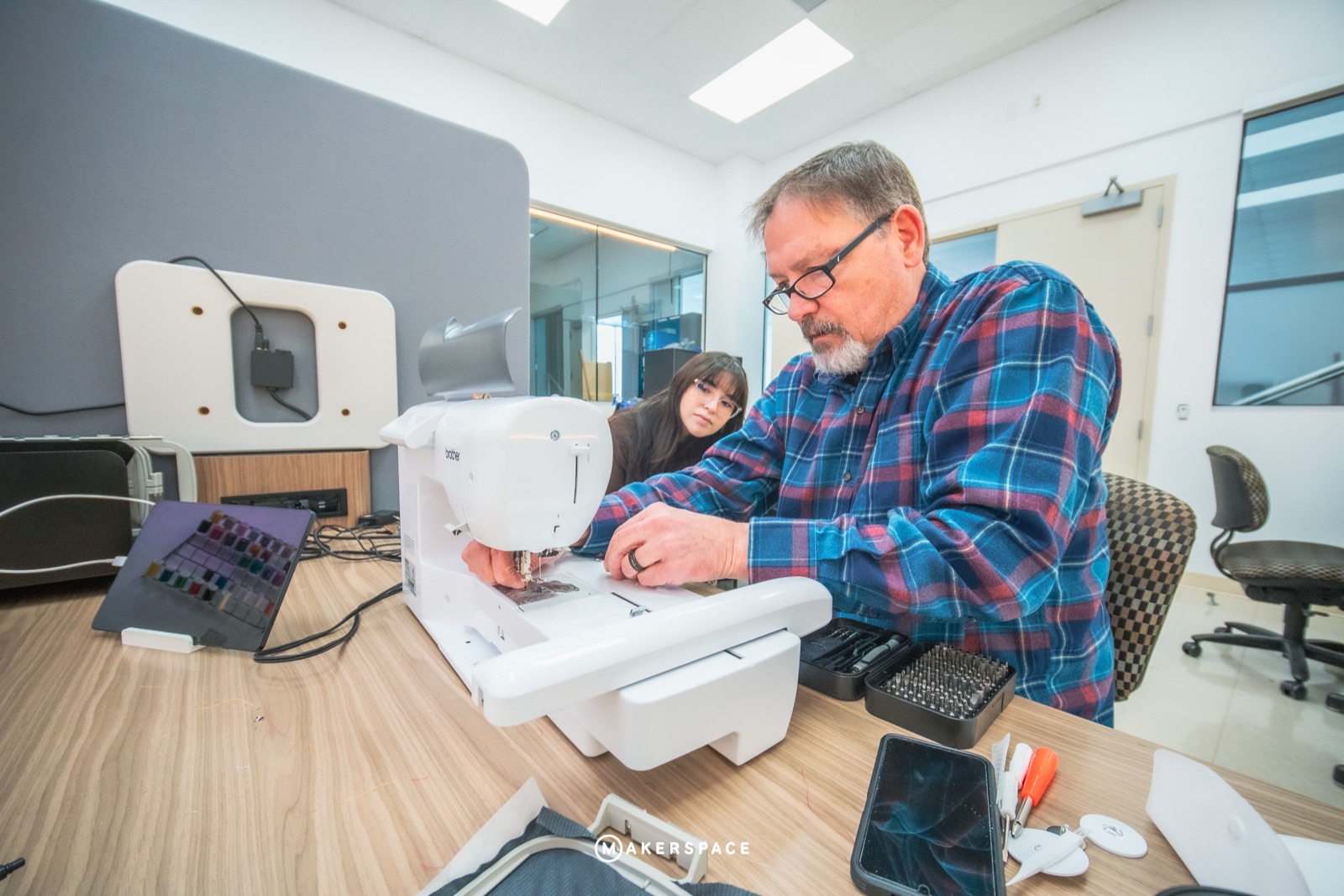 Maker sewing at a machine
