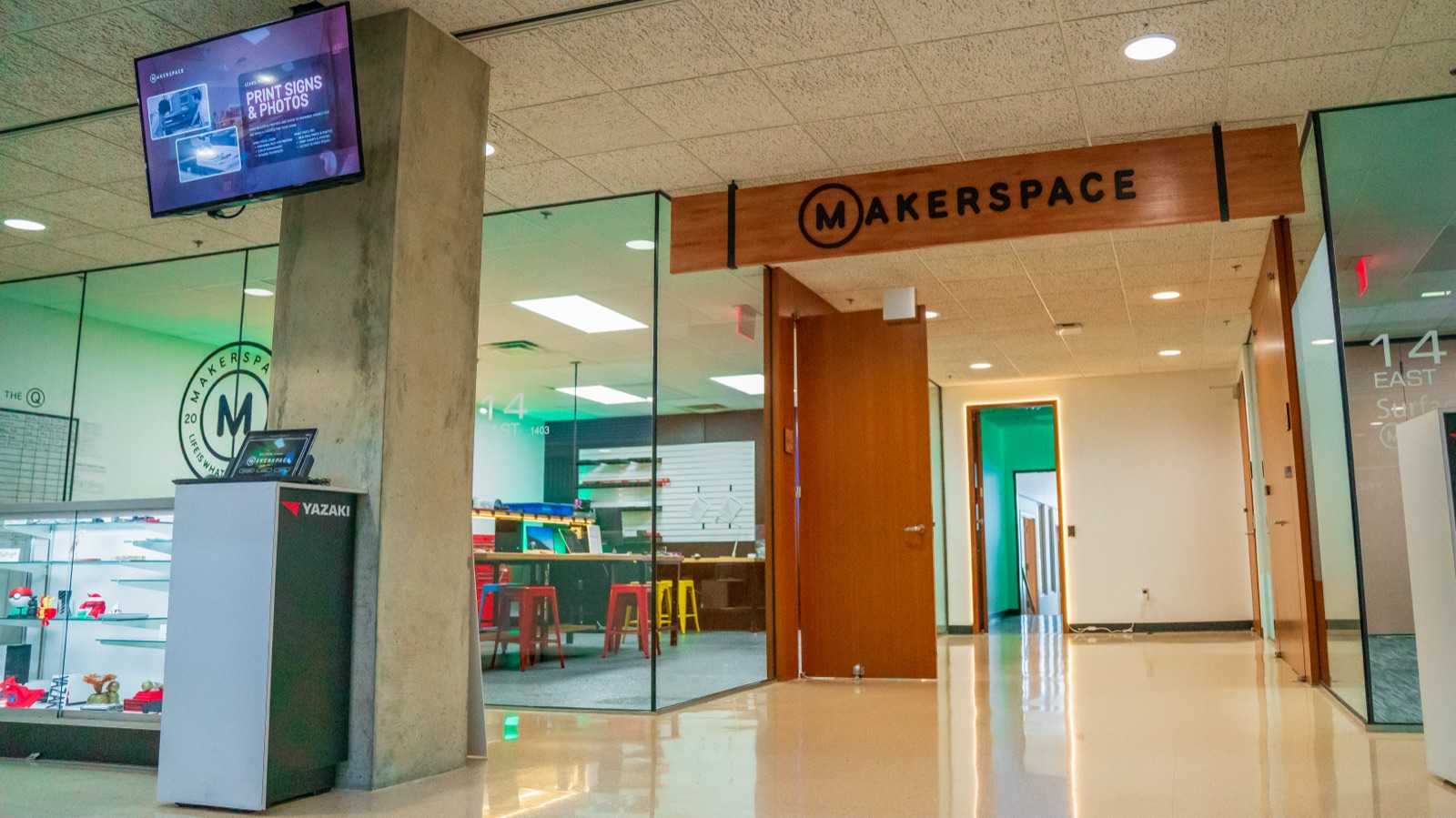 Glass storefront entrance with the Makerspace sign