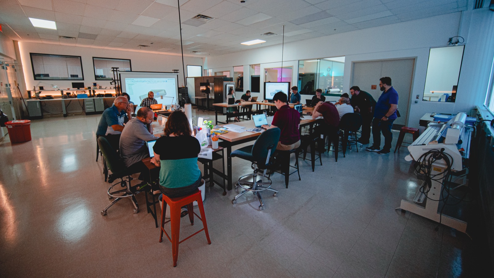 Group seated at long tables in the Makerspace