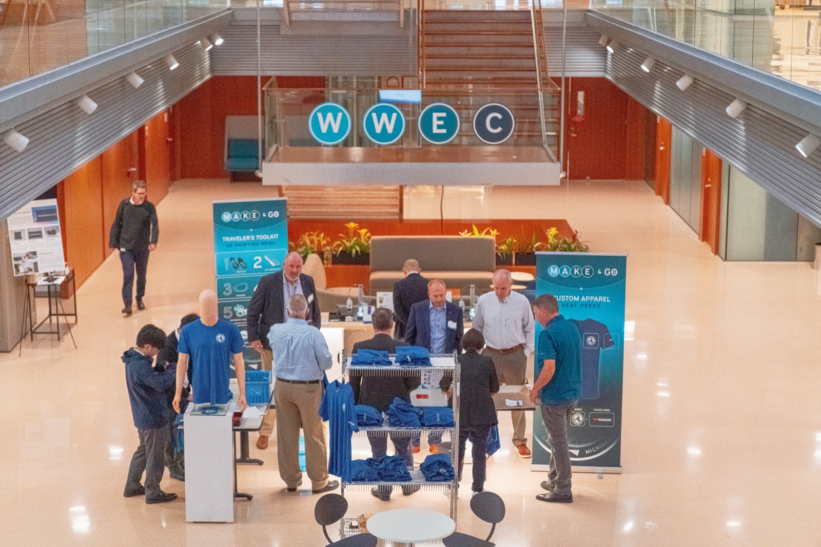 Crowd around Makerspace tables in the WWEC atrium