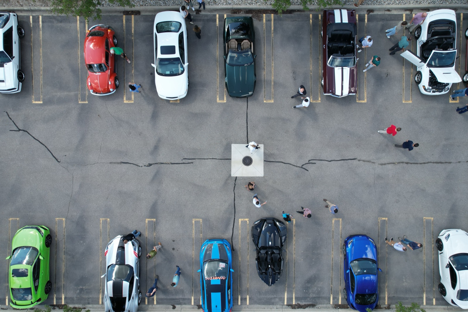 Overhead drone view of cars parked in rows
