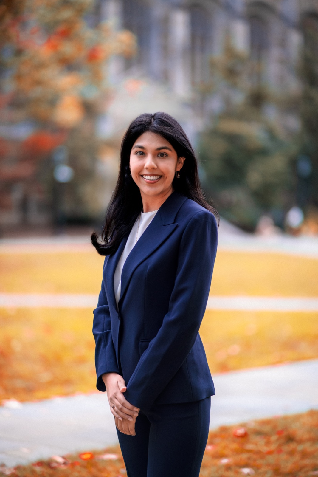 Woman in a navy suit outdoors in autumn
