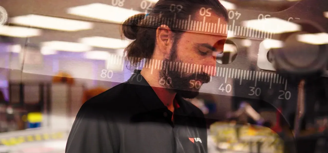 An engineer at work on a harness build
