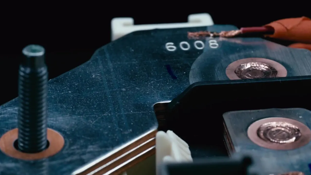 Laser-welded copper terminals on a busbar stamped 6008, close up on black