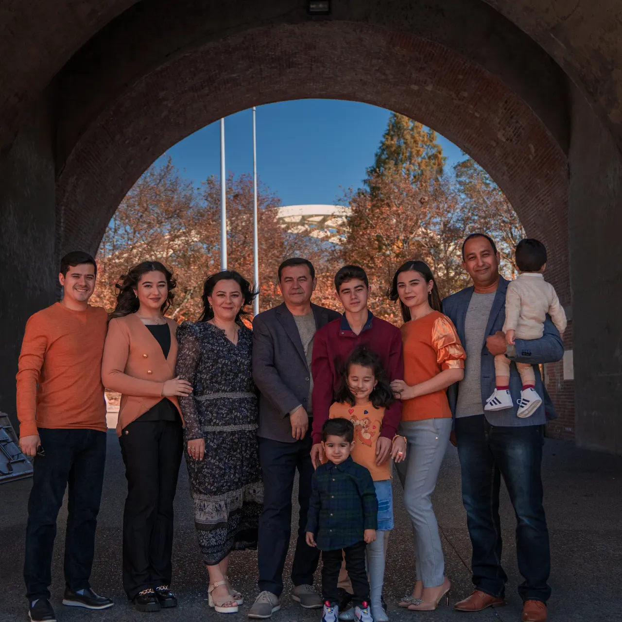 A big family under a stone archway