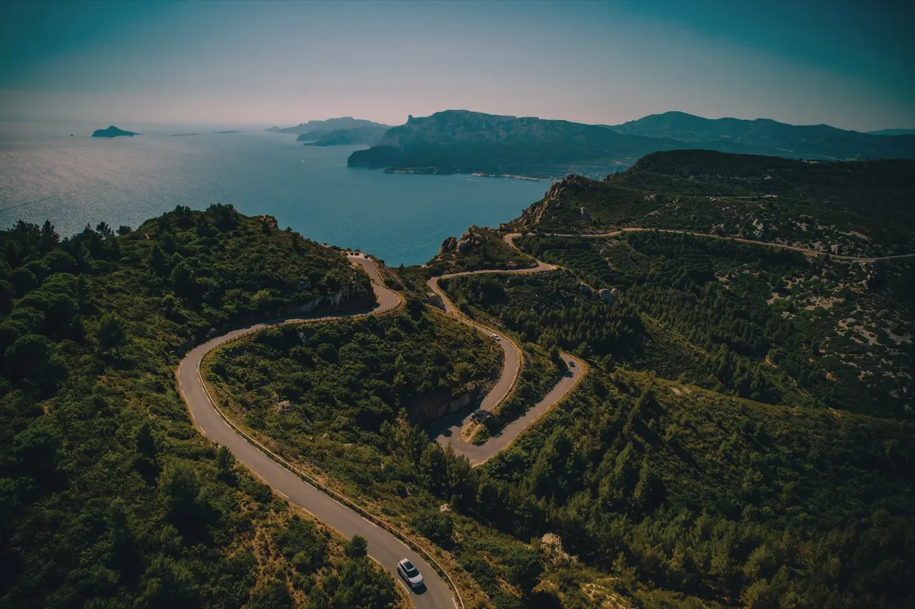 Switchback road winding toward the sea